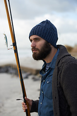 Image showing Thinking, fishing and man at a beach for water hobby, recreation or stress relief in nature. Rod, waiting and male fisherman at the ocean for travel, journey or collecting fish adventure in Cape Town