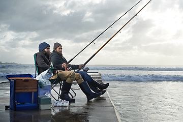 Image showing Ocean, rod for fishing and men outdoor in winter, leisure activity at beach or harbor with friends in nature for seafood. Travel, seascape and waves with fisherman, recreation or hobby in the cold