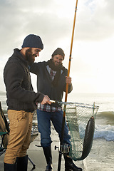 Image showing Fishing, friends and net with fish at pier with rod, waves and relax on vacation, holiday and adventure. Friendship, men and bonding in morning with overcast, sky and nature for activity and hobby