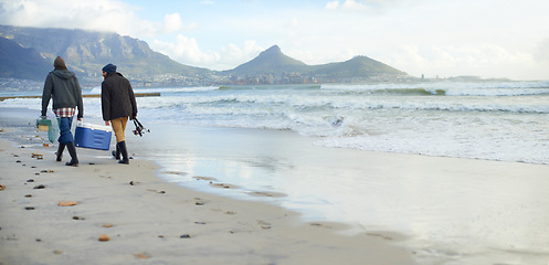 Image showing Fishermen, equipment or walking on beach for fishing on cloudy morning or afternoon in Cape Town. Friends, men or male tourists with net, pole and cooler box by sea, shore or coast for mockup