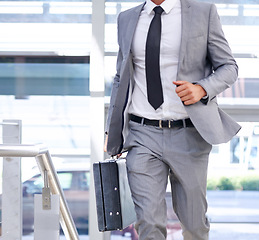 Image showing Businessman, suitcase and walking with fashion for travel, immigration or rushing to office. Closeup of man or employee in stylish suit with briefcase in a hurry for business opportunity or traveling