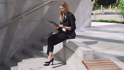Image showing Professional Businesswoman Using Tablet on Concrete Steps