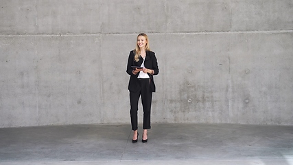 Image showing Confident Businesswoman Standing with Tablet in Modern Office