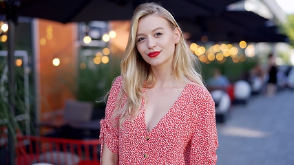 Image showing Elegant Woman Enjoying Evening at Outdoor Cafe