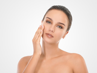 Image showing Portrait, woman and touching face for moisturizing skincare, wellness with white background. Mockup, female person and hand with glow, flawless skin and natural makeup for selfcare in studio