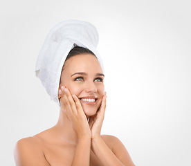 Image showing Portrait, woman and hands for moisturizing skincare with smile, head towel and white background. Mockup of female person, glow and natural makeup for self care, spa treatment and flawless skin