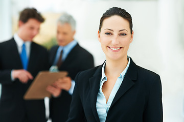 Image showing Woman, portrait and colleagues in background of office with smile for business of corporate company. Person, happy and professional as employee with suit and collaboration with team to work for job