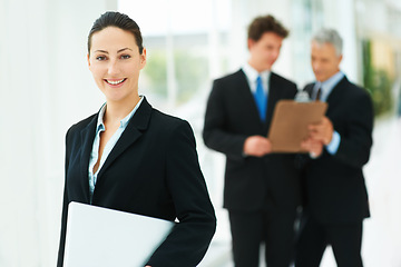 Image showing Professional, woman and portrait in company with laptop and team in lobby of London office. Happy, person and business people in workplace with report, checklist and collaboration on project