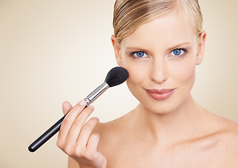 Image showing Cosmetics, brush and mockup portrait of woman in studio with confidence, makeup or facial glow. Glamour, beauty and happy face of girl on beige background space with healthy skin, shine and wellness.