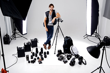 Image showing Portrait, smile and man with gear, photography and equipment in a work studio with confidence. Person, photographer and entrepreneur with tools or lights with startup and freelancer with professional