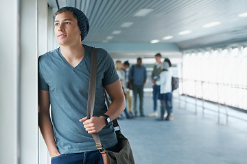 Image showing University, college and man in hallway thinking for learning, studying and knowledge. Thoughtful, academy and happy student by window with backpack for scholarship, school and education on campus