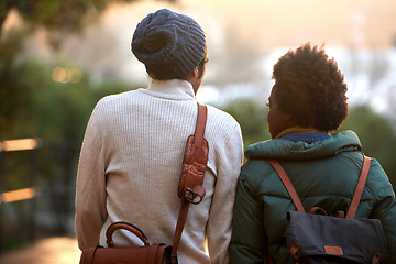 Image showing Back view, university student and friends in outdoor on campus, contemplate and relax with backpack in cold weather. College, interracial and classmate for chill, think and plan for assignment.