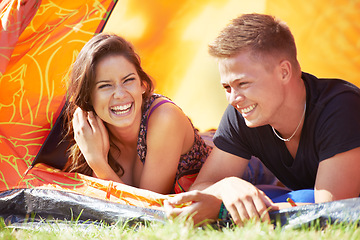 Image showing Happy couple, tent and laughing for funny joke, humor or bonding together at outdoor campsite. Face of young man and woman with smile enjoying fun holiday weekend, vacation and camping on green grass