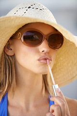 Image showing Closeup, portrait and woman with lip gloss for beauty, makeup and glow during hot summer day. Female person, tourist and cosmetics with glossy lipstick, straw hat, and sunglasses in Portugal