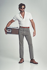 Image showing Men, fashion and confident with radio on retro in studio, grey background and smart clothes with elegant style. Trends, vintage and fashionable with old school in Italian look and classic outfit.
