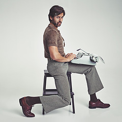 Image showing Man, vintage and pipe with typewriter in studio on grey background, confident and typing in chair. Fashion, retro and smart style in old school with elegance on fashionable and fancy clothes.