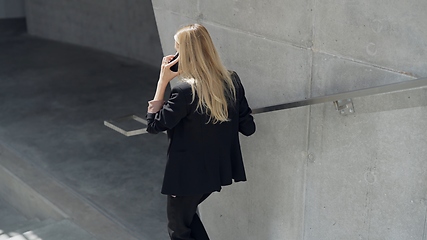 Image showing Professional Woman Talking on Phone in Modern Setting