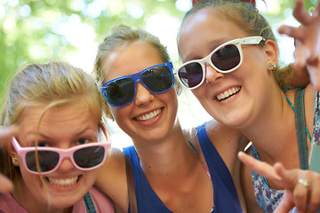 Image showing Sunglasses, friends and portrait of women in nature on holiday, vacation and weekend outdoors. Happy, fashion and people with trendy style for bonding, fun and relax on adventure, travel and trip