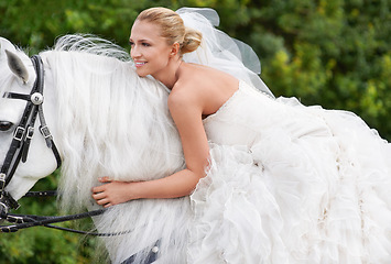 Image showing Bride, woman and riding with horse outdoor or happiness for celebration, marriage and confidence in countryside. Wedding, person and stallion on lawn in field with smile, dress and animal at ceremony