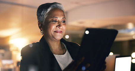 Image showing Business woman, manager and tablet at night in office to search online report, scroll information and website planning. Happy mature entrepreneur working late on digital data with social network app