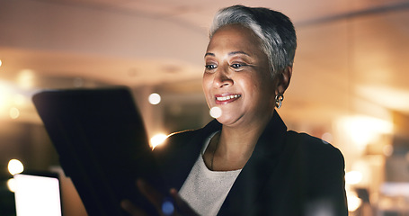 Image showing Business woman, manager and tablet at night in office to search online report, scroll information and website planning. Happy mature entrepreneur working late on digital data with social network app