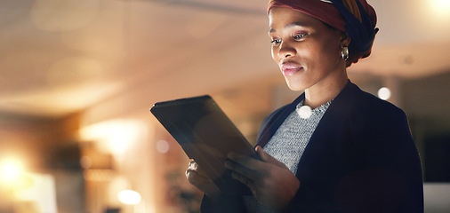 Image showing Business, happy black woman and tablet at night in office to search online report, scroll information and website planning. Corporate employee working late on digital data, tech or social network app