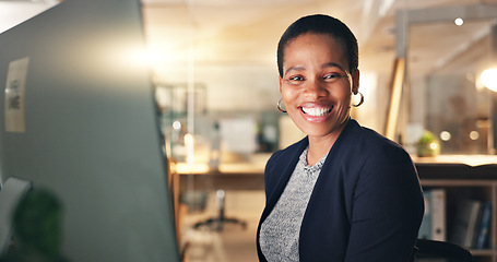 Image showing Face, happy and black woman in office at night for business on a computer during overtime. Smile, workspace and portrait of an African employee with a pc for a late deadline or working in corporate