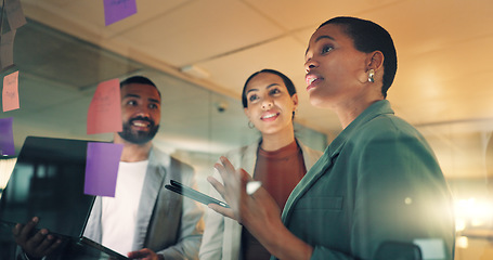 Image showing Business woman, presentation and notes on board in an office for training, meeting or ideas. Men and women talking about strategy, planning or pitch with technology, leader and a team at night