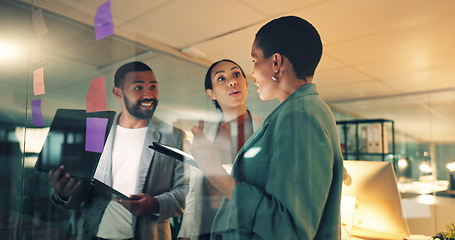 Image showing Business woman, tablet and notes on board in an office for training, meeting or ideas. Men and women talking about strategy, planning or scrum for pitch with technology, leader and a team at night