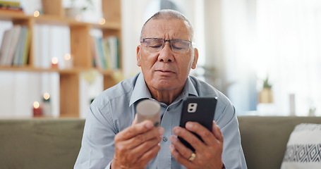 Image showing Phone, pills and senior man at home, reading label, medicine information and confused for telehealth service or FAQ. Elderly person on sofa with pharmaceutical bottle or tablet with mobile questions