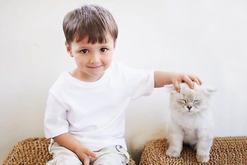 Image showing Child, boy and portrait with kitten for pet, best friend and bonding with happiness in living room of home. Toddler, kid and face with animal, cat and friendship in lounge of house or apartment