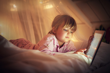 Image showing Child, bedroom and tablet at night, browsing and watching with technology for screen and streaming. Little girl, tech and internet for online games or digital reading with touch and holding in bed