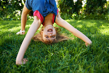 Image showing Child, back and bend or bridge or outdoor play in summer or flexibility game or practice, fun or backyard. Kid, face and excited or gymnastics stretching on grass lawn in London park, happy or garden
