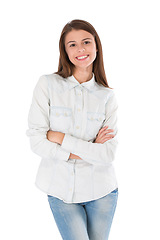 Image showing Woman, portrait and arms crossed with work fashion, style and trendy clothing with a smile in studio. Happy, creative designer and confidence with modern and clothes with white background and jeans
