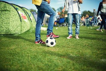 Image showing Man, feet and playing with soccer ball outside of his tent group of colourful camping. Row of marquees placed on ground at musical concert, entertainment event and carnival celebration sporty party