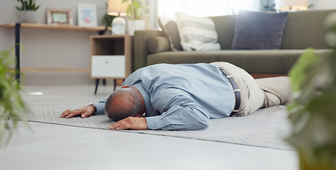 Image showing Man, faint and accident on home floor with heart attack, cardiac arrest or unconscious in living room. Mature person on ground and alone with medical risk, emergency and healthcare problem or death