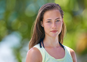 Image showing Portrait, nature and woman with confidence, summer and freedom with weekend break and happiness. Face, person and girl in a park and carefree with casual outfit and fresh air with sunshine and joy