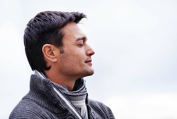 Image showing Cloud sky, thinking and man with peace, ideas and wellness with stress relief and freedom. Person, outdoor and guy with confidence and happiness with choice and wonder with thoughts and carefree