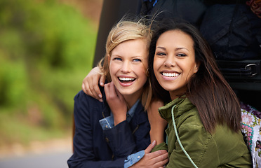 Image showing Happy woman, friends and hug for road trip, vacation or outdoor holiday together at the back of a van. Female person with smile for friendship, summer break or freedom in relax by vehicle or car