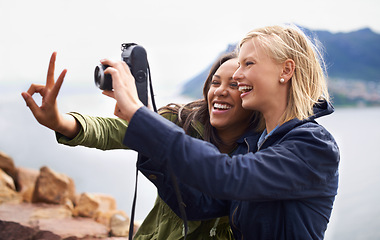 Image showing Happy woman, friends and laughing with peace sign or camera for funny photography or moments together in nature. Female person with smile for photo, picture or memories of emoji on outdoor holiday