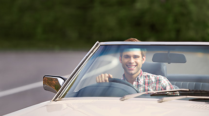 Image showing Happy man, portrait and driving car for road trip, travel or adventure on outdoor adventure. Young male person with smile in vehicle for transportation, holiday getaway or drive on street in nature