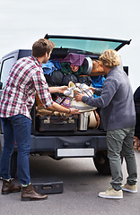 Image showing Men, friends and luggage in car trunk on road trip or camping outdoor for holiday, vacation or adventure. Male people, bags and unpacking boot or transportation together in Europe, journey or travel