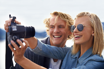 Image showing Happy couple, camera and selfie in photography for travel, memory or outdoor moment together in nature. Face of young man and woman with smile for photo, picture or capture on adventure or journey