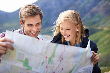Image showing Happy people, friends and map with location for travel or destination on mountain in nature. Young couple with smile, document or geographic paper with routes for navigation, help or outdoor tourism