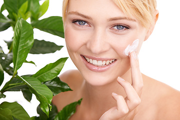 Image showing Cream on face, leaves and woman with beauty for dermatology organic cosmetics and smile on white background. Portrait, lotion or sunscreen with green plant for eco friendly skincare and moisturizing