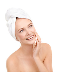 Image showing Smile, skincare and woman touch face, beauty or cosmetics in studio isolated on a white background. Spa, hand and happy person with towel in treatment for dermatology, soft skin or thinking of makeup