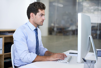 Image showing Business, employee and man with a computer, typing and internet with research and online reading. Person, accountant and financial adviser with a pc and connection with company website, tech and info