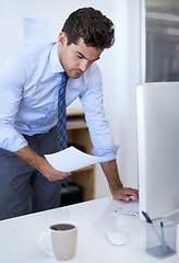 Image showing Businessman, computer and paperwork in office for online research for feedback review, planning or brainstorming. Male person, document and financial consultant for budget, accounting or investing