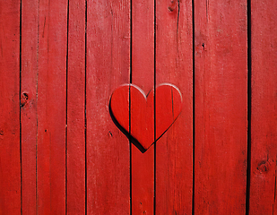 Image showing Red painted wooden wall with heart as a symbol of love and frien
