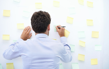 Image showing Businessman, writing and sticky notes in office for strategy, brainstorming and project planning with rear view. Entrepreneur, employee and ideas for agenda, schedule and proposal information at work